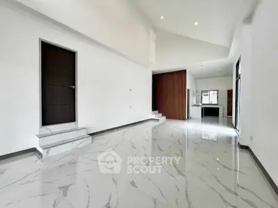 Spacious modern living room with high ceilings and elegant marble flooring