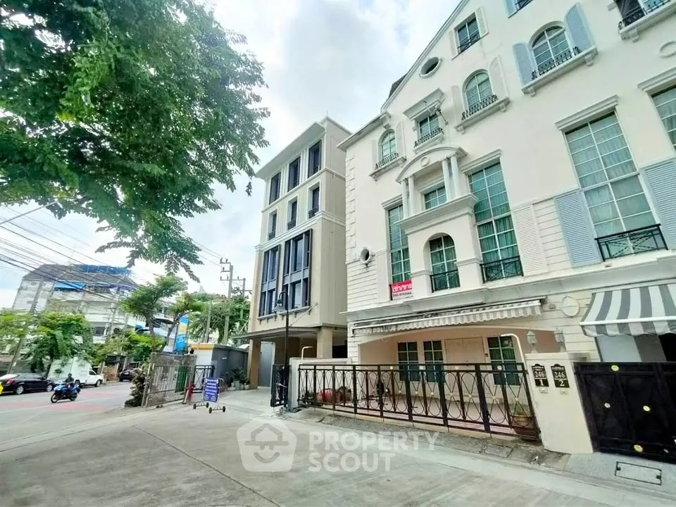 Charming townhouse with classic facade and gated entrance in urban setting