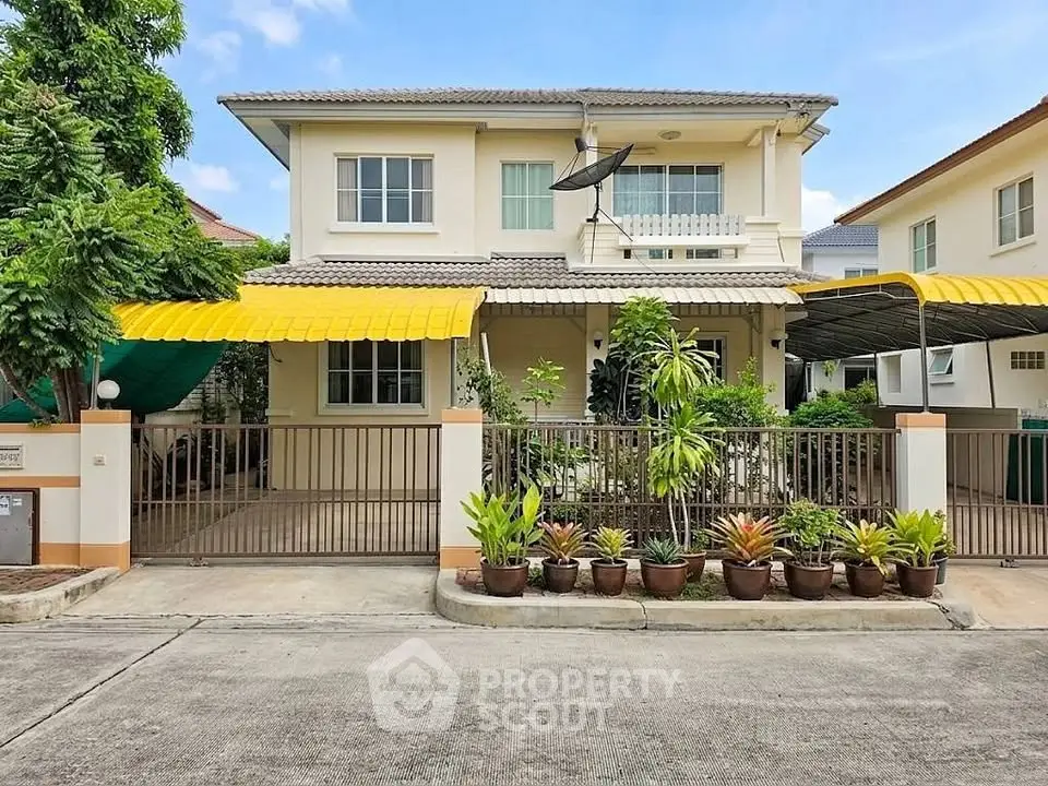 Charming two-story house with lush garden and spacious driveway in a serene neighborhood.