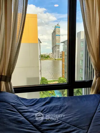 Stunning river view from a cozy bedroom window in a modern apartment.