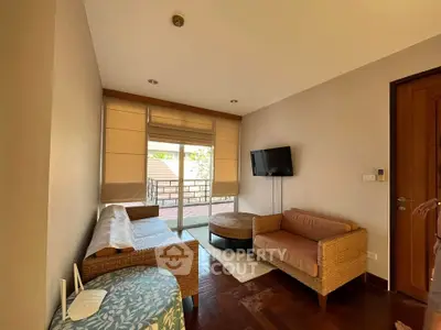 Cozy living room with wicker furniture and balcony access