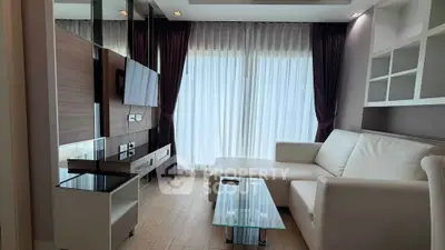 Modern living room with sleek furniture and large window curtains