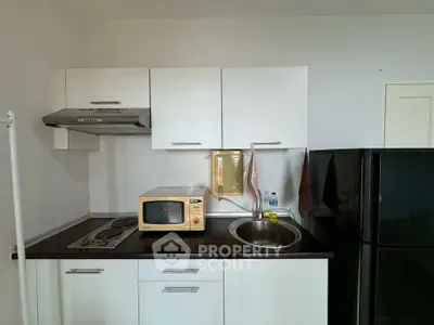 Compact kitchen with modern appliances and sleek cabinetry