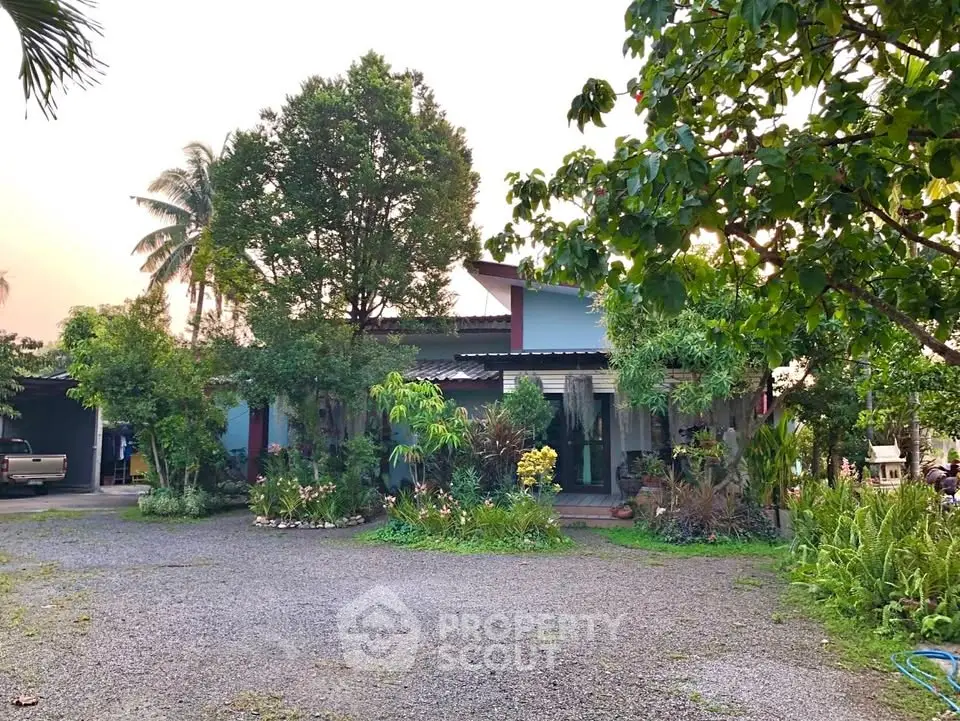 Charming countryside home surrounded by lush greenery and spacious driveway, perfect for nature lovers.