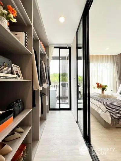 Stylish bedroom with walk-in closet and balcony view