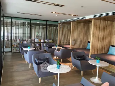 Modern lounge area with stylish seating and wooden accents, perfect for relaxation and social gatherings.