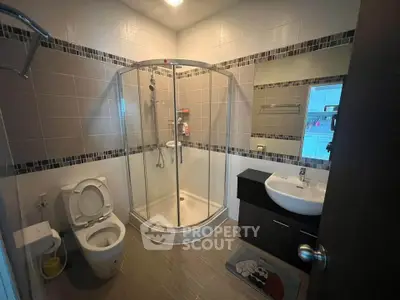 Modern bathroom with glass shower enclosure and sleek fixtures