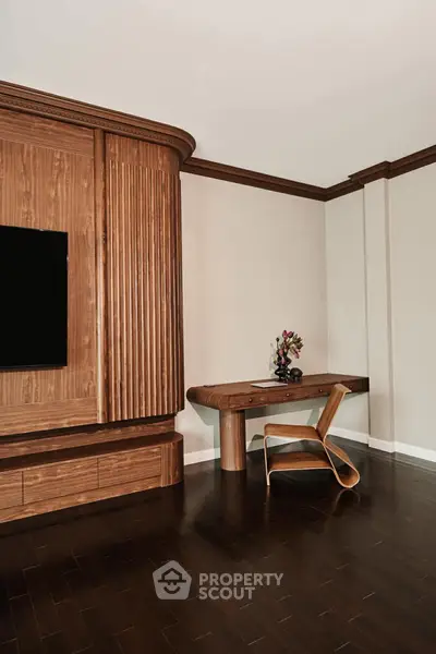 Elegant study area with modern wooden desk and chair, perfect for productivity.