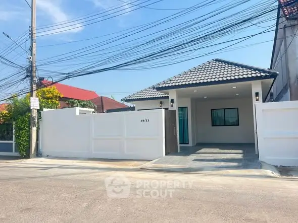 Charming single-story home with modern design and spacious driveway in a serene neighborhood.