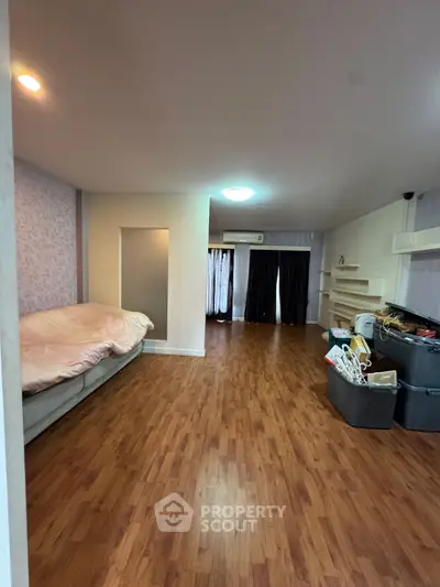 Cozy bedroom with wooden flooring and modern decor