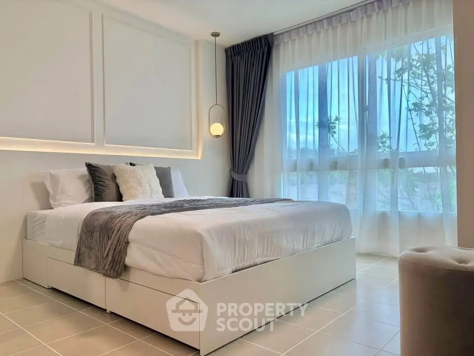 Elegant bedroom with large window and modern decor