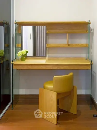 Modern study nook with wooden desk, glass shelves, and stylish chair in cozy home interior.