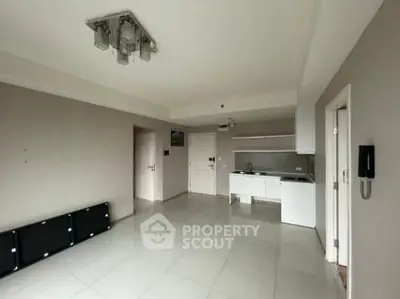 Modern minimalist kitchen with sleek white cabinetry and tiled flooring