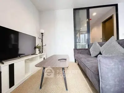 Modern living room with sleek furniture and large TV, perfect for relaxation and entertainment.