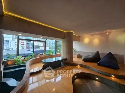 Luxurious indoor space with modern design and city view, featuring cozy seating and ambient lighting.