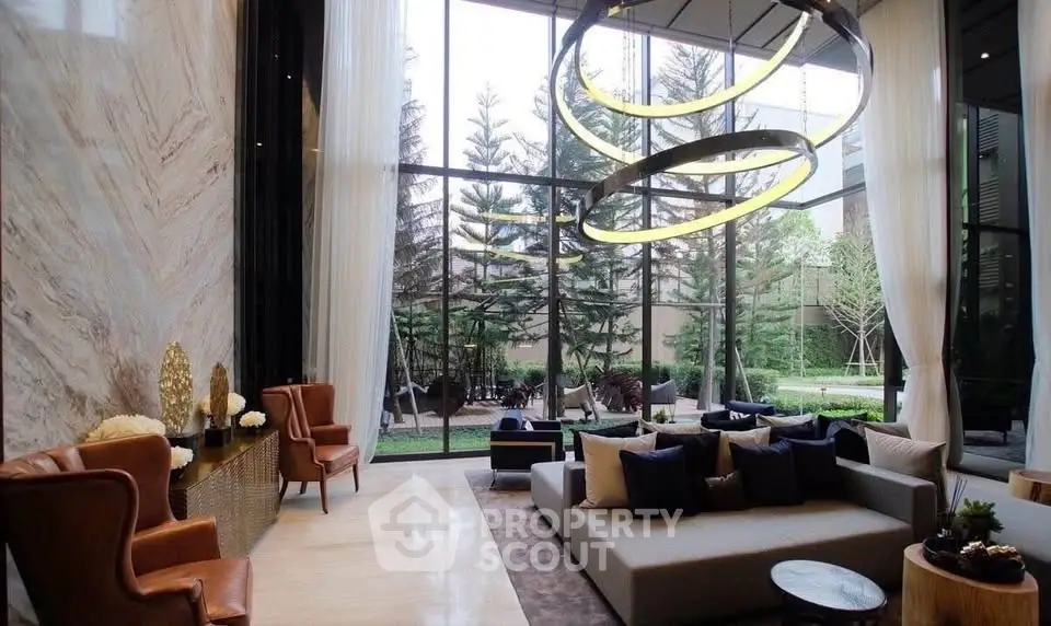 Luxurious living room with high ceilings and garden view, featuring modern furniture and elegant lighting.