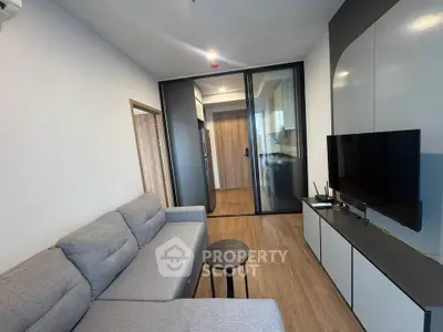 Modern living room with sleek design and open kitchen layout
