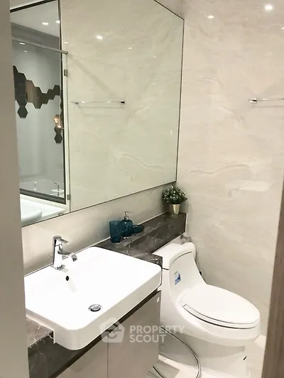 Modern bathroom with sleek fixtures and elegant marble accents.
