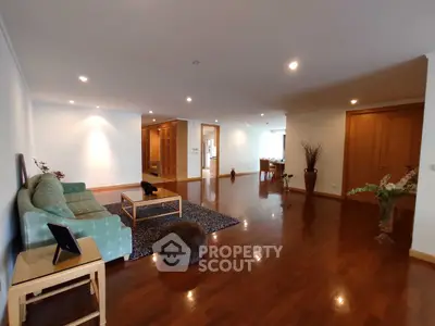 Spacious living room with elegant wooden flooring and modern decor