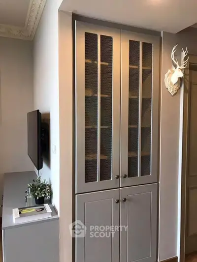 Stylish living room with modern cabinet and wall-mounted TV, perfect for contemporary living.