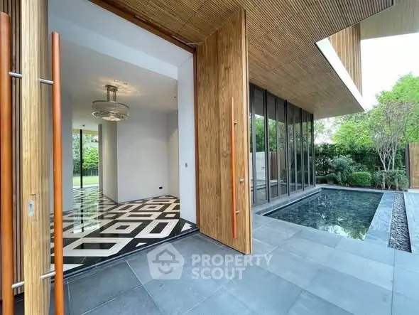 Modern luxury home entrance with pool and stylish interior design