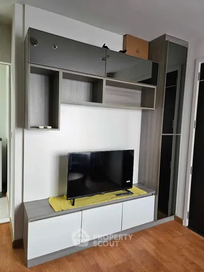 Modern living room with sleek TV unit and stylish storage solutions.