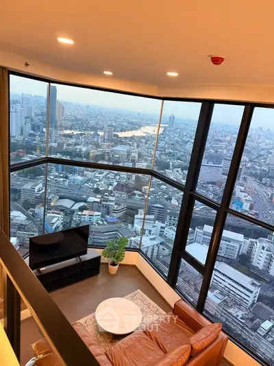 Stunning high-rise living room with panoramic city views and modern furnishings.