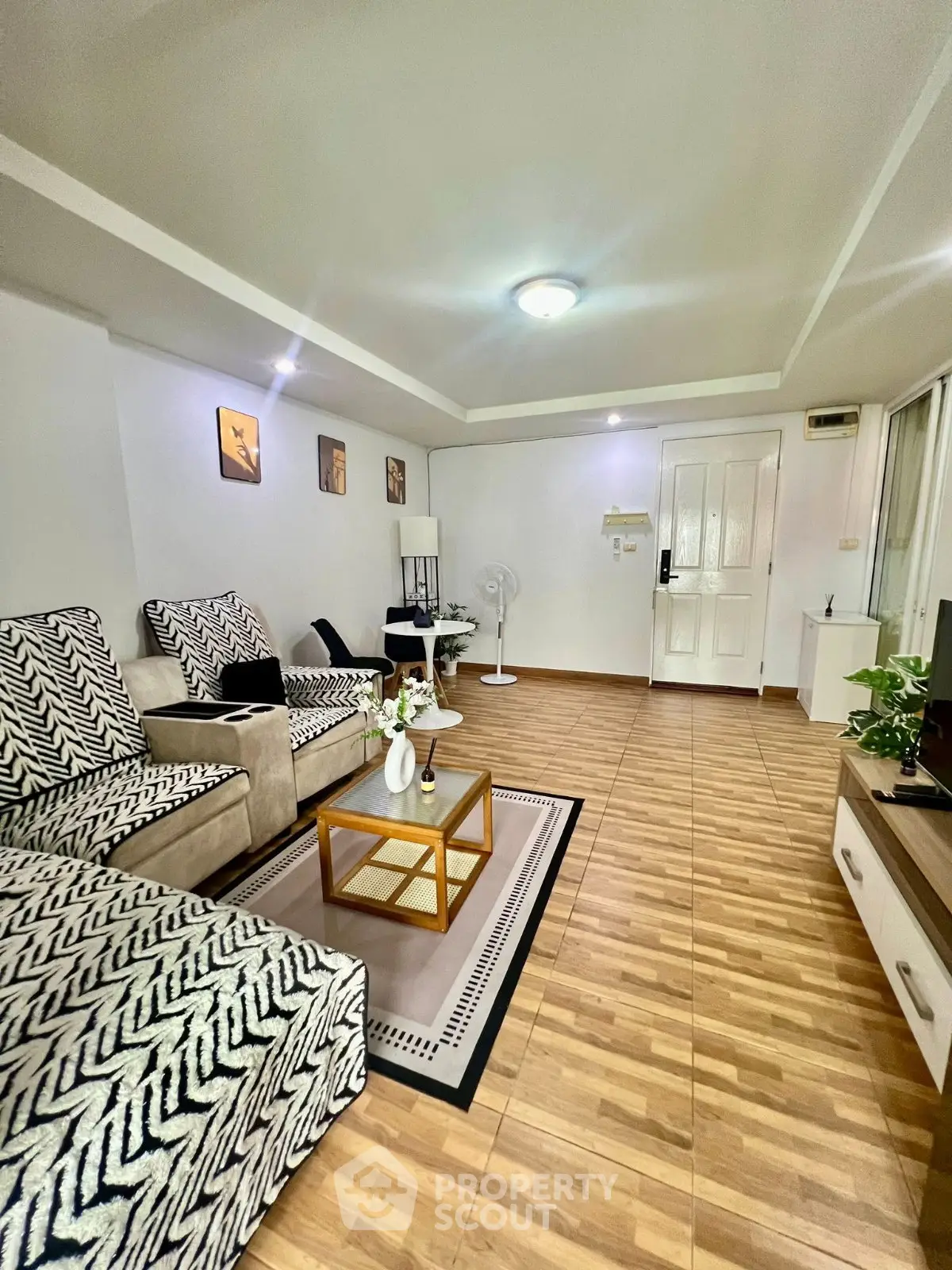 Spacious living room with stylish decor and modern furniture, perfect for relaxation and entertainment.