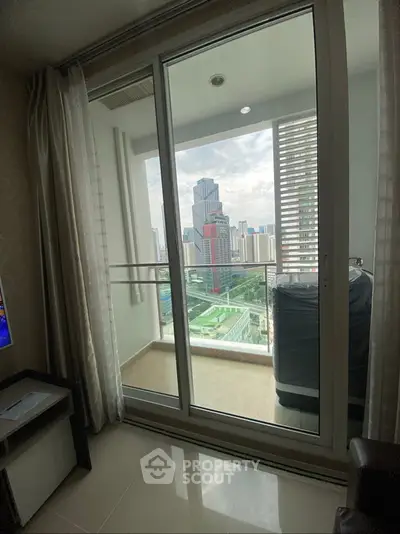 Modern apartment with city view from balcony, featuring sleek sliding glass doors and elegant interior design.
