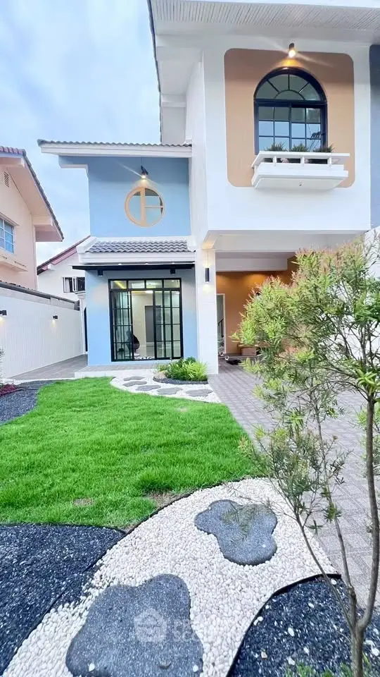 Charming two-story house with modern facade and lush garden pathway.