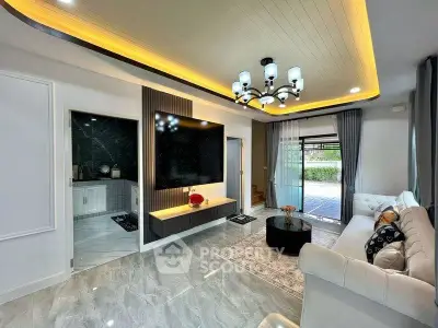 Luxurious living room with modern lighting and elegant decor, featuring a spacious layout and stylish furnishings.