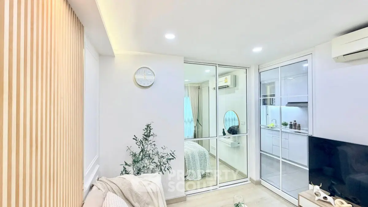 Modern living room with open kitchen and cozy bedroom view