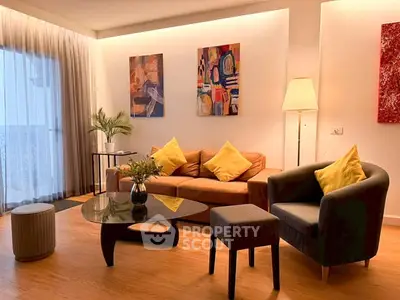 Stylish living room with modern furniture and vibrant artwork, perfect for relaxation and entertaining.