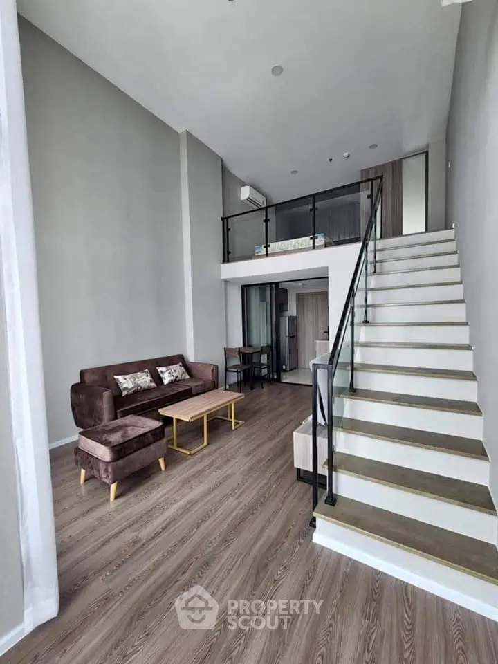 Modern loft apartment with high ceilings and stylish staircase