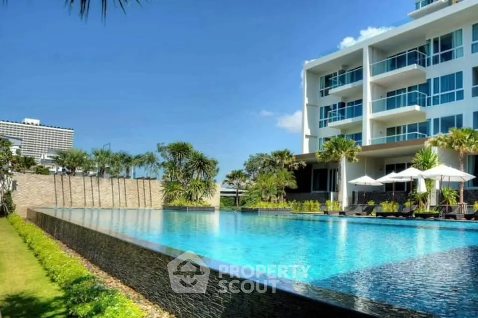 Luxurious apartment complex with stunning pool and modern architecture.