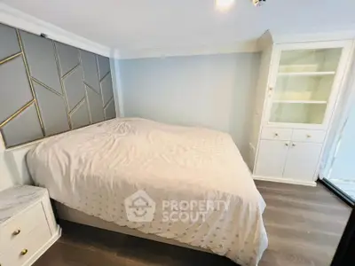 Cozy bedroom with elegant decor and built-in storage, perfect for relaxation.