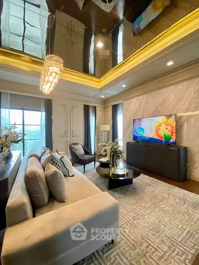 Luxurious living room with elegant decor and large windows, featuring a plush sofa and modern chandelier.