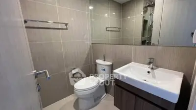 Modern bathroom with sleek fixtures and neutral tiles