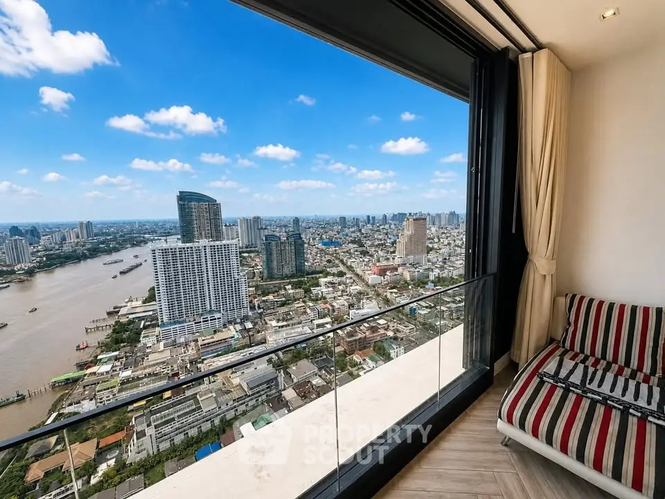 Stunning high-rise apartment with panoramic city and river views from a spacious balcony.