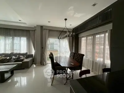 Spacious living room with elegant dining area and natural light