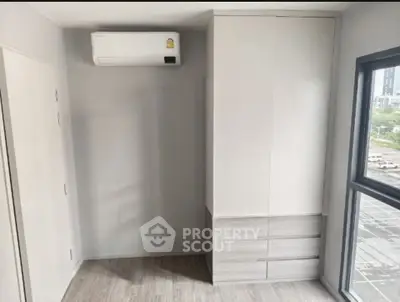 Modern minimalist bedroom with built-in wardrobe and air conditioning