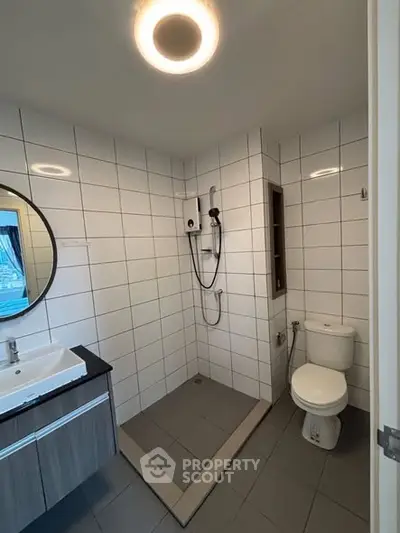Modern bathroom with sleek shower and stylish vanity in a contemporary home.