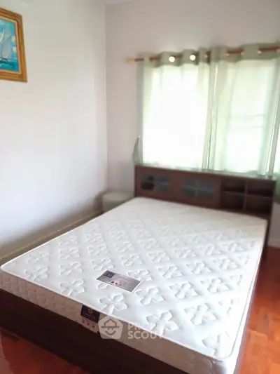 Cozy bedroom with natural light and modern furnishings, perfect for relaxation and comfort.