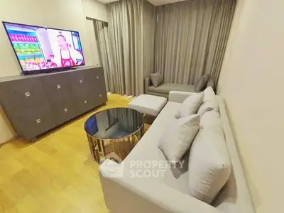 Modern living room with sleek furniture and large TV, perfect for relaxation.