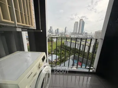 High-rise balcony with cityscape view and washing machine, perfect for urban living.