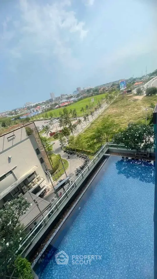 Stunning rooftop pool with panoramic city views and lush greenery