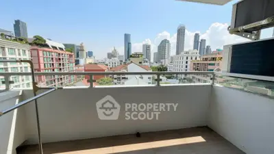 Spacious balcony with stunning city skyline view, perfect for relaxation and enjoying urban living.