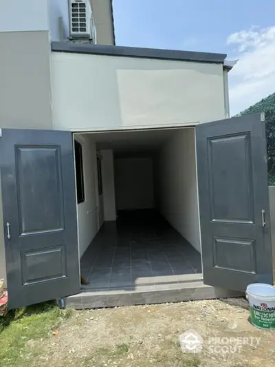 Spacious storage room with double doors and tiled flooring in modern building