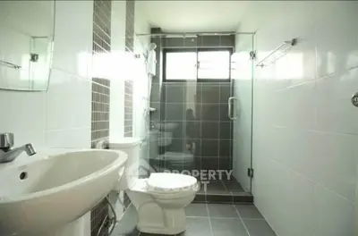 Modern bathroom with glass shower and sleek tile design