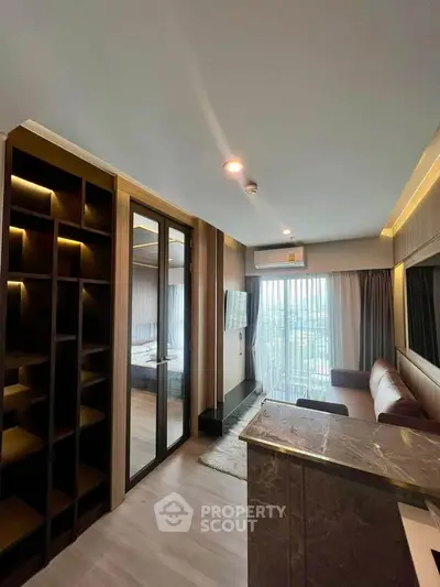 Modern living room with stylish decor and large windows offering natural light.